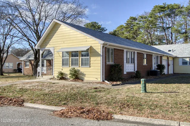 a view of a house with a yard covered in snow