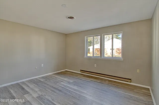 a view of a room with wooden floor and window