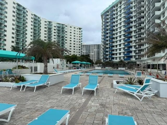 a view of a patio with couches table and chairs and potted plants