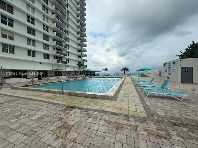 a view of a swimming pool with a bench