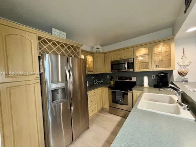 a kitchen with a refrigerator stove and sink