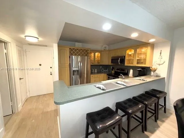a large kitchen with a table and chairs