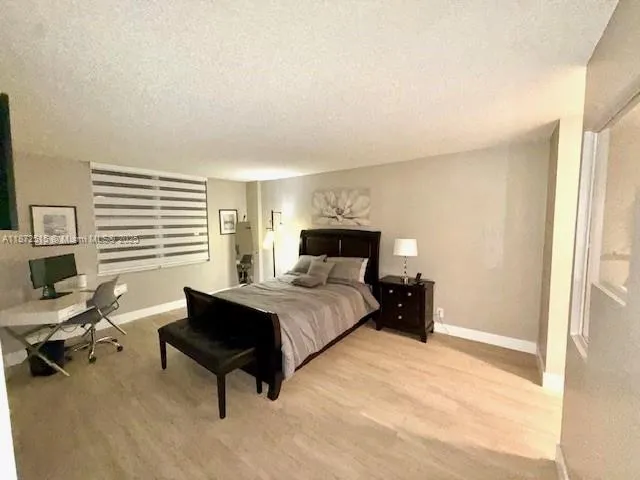 a bed room with a bed and a chair