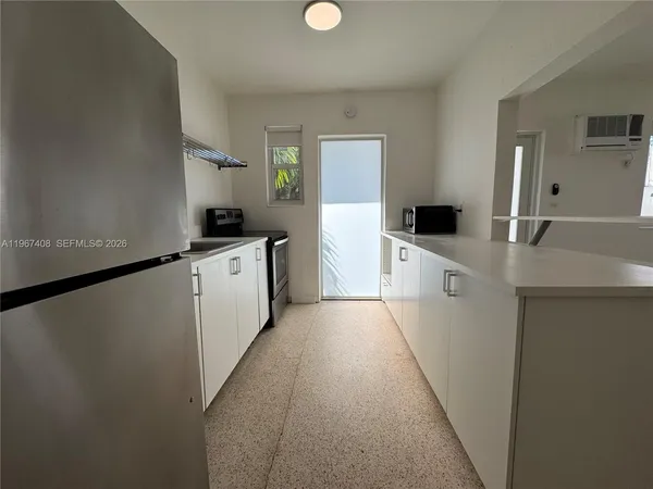 a kitchen with a sink a stove and cabinets