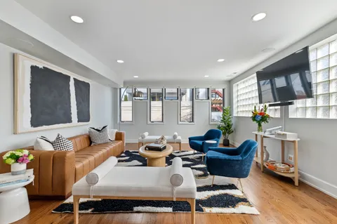 a living room with furniture a rug and a window