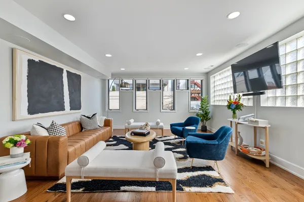 a living room with furniture a rug and a window