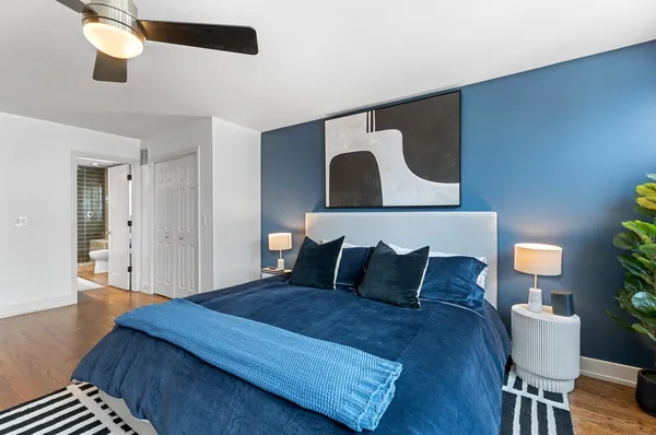 a bedroom with a bed and wooden floor