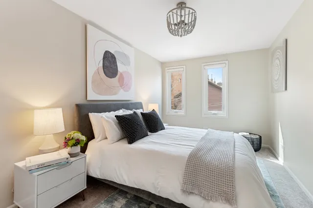 a bedroom with bed and a window