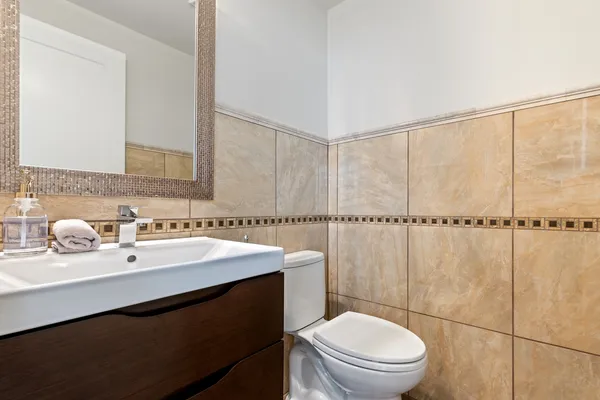 a bathroom with a sink a toilet and vanity
