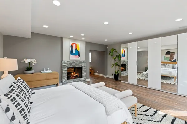 a spacious bedroom with a bed and a fireplace