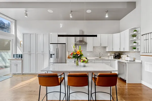 a kitchen with stainless steel appliances a sink and a refrigerator