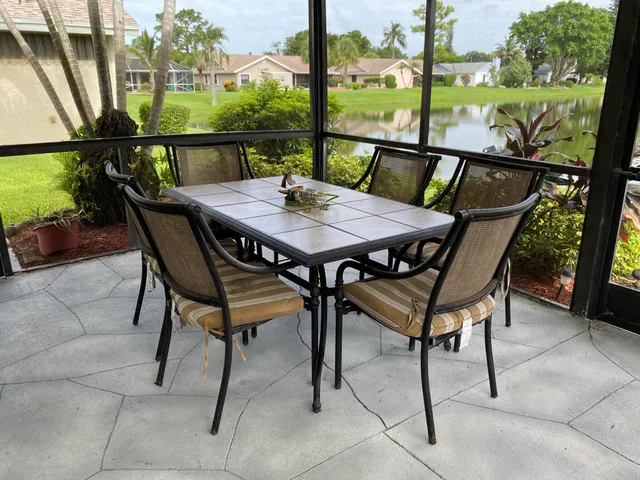 a view of a dining table and chairs on the roof deck