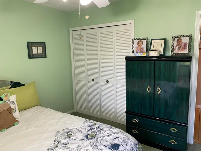 a room with a bed and a television