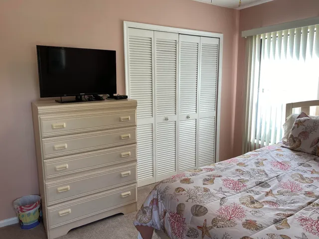 a bedroom with a bed and a television in it