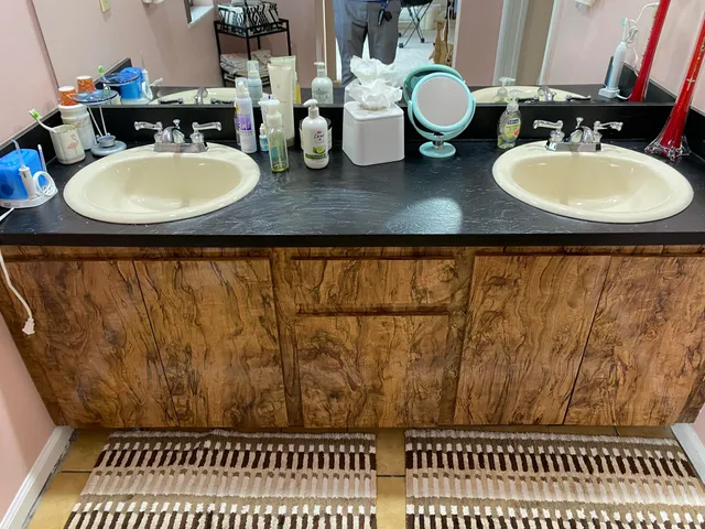 a bedroom with a bed wooden floor and large mirror