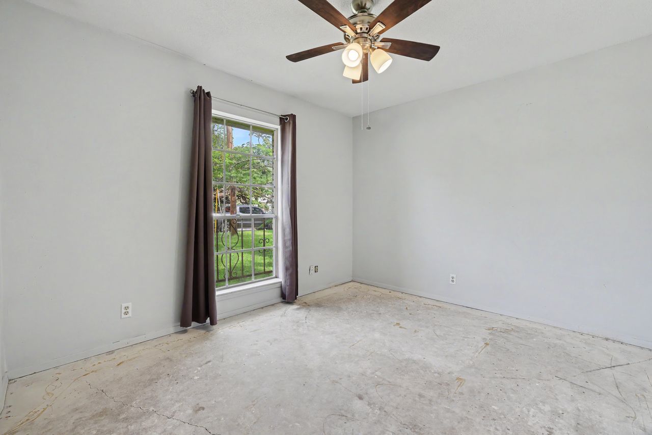 1811 Terry Lane Georgetown, TX 78628 - Photo 26 of 40 Ready for your personal touch, this room features a large window for natural light and a ceiling fan for comfort.