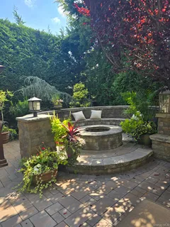 a view of a patio with table and chairs and potted plants