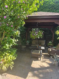 a view of backyard with outdoor seating and flowers