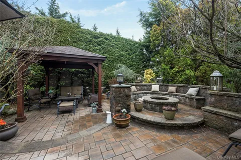 a view of a patio with chairs and plants