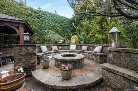 a view of a patio with couches chairs and a fire pit