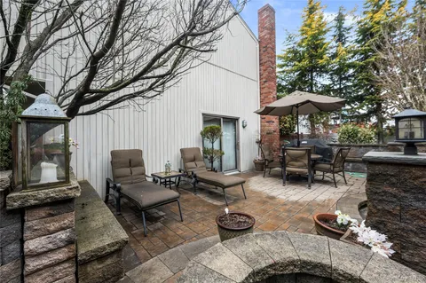 a view of a patio with fire pit and furniture