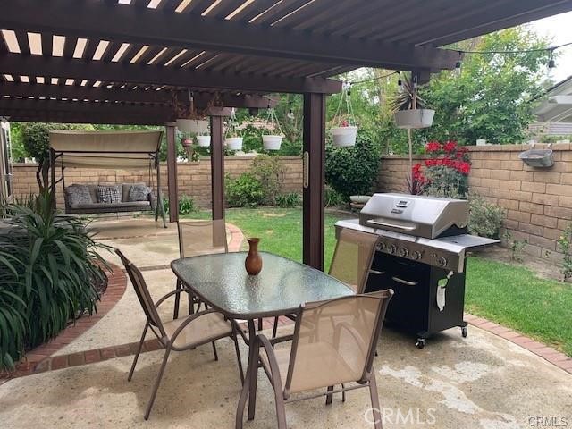 21897 Shenandoah Drive Lake Forest, CA 92630 - Photo 11 of 12 a patio table and chairs with potted plants and a barbeque grill