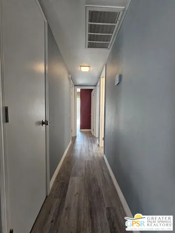 a view of hallway with wooden floor