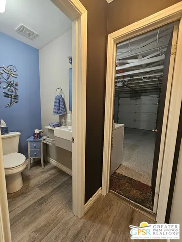 a bathroom with a toilet sink and vanity