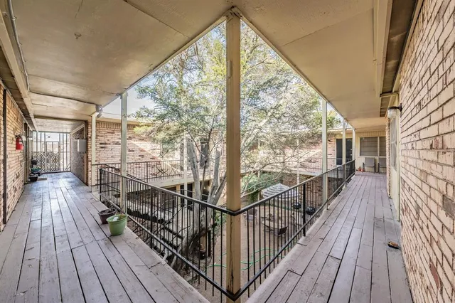 a view of balcony with wooden floor