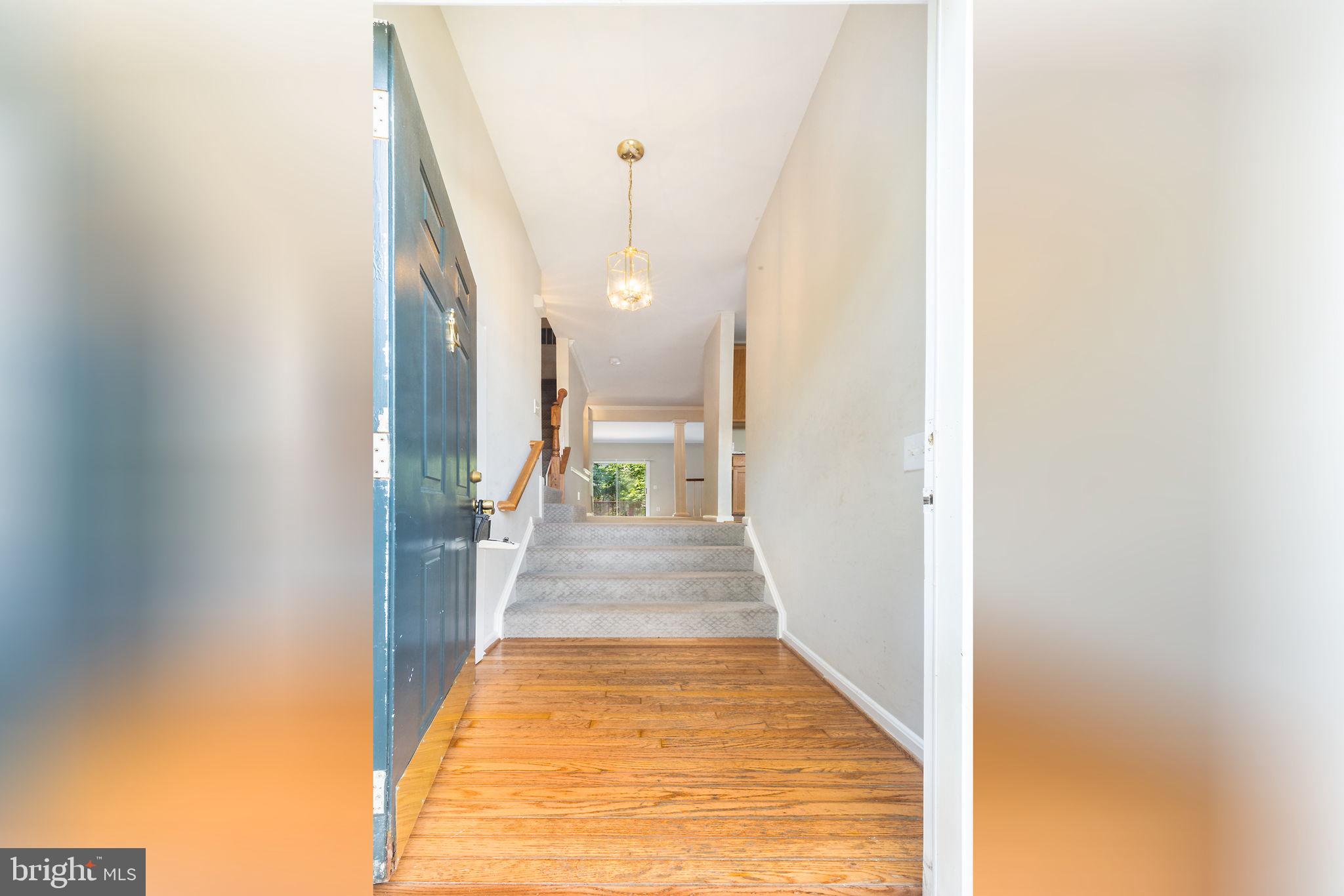 43115 Candlewick Square Leesburg, VA 20176 - Photo 6 of 31 a view of a hallway with wooden floor and a floor to ceiling window
