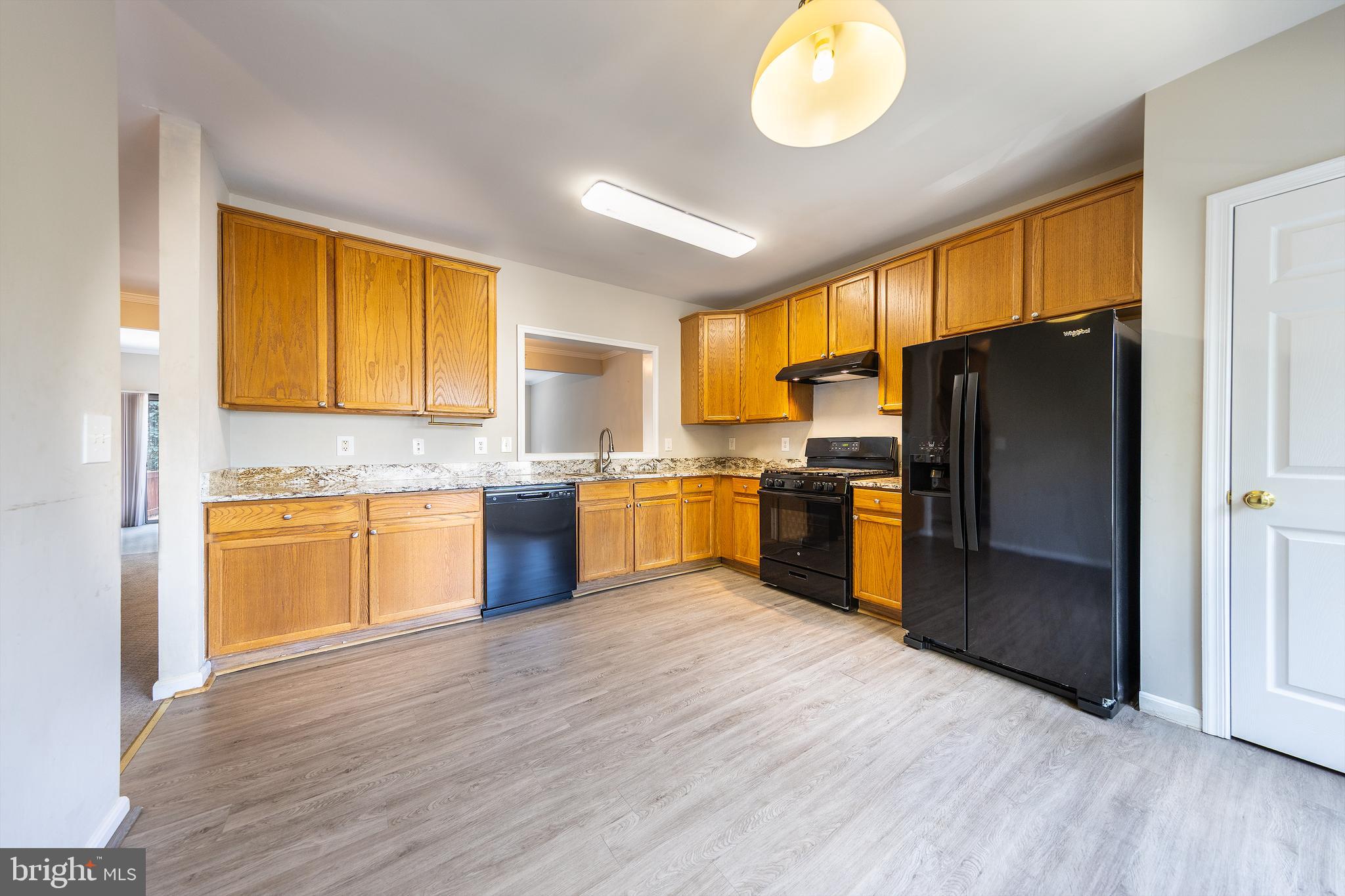 43115 Candlewick Square Leesburg, VA 20176 - Photo 8 of 31 a kitchen with granite countertop stainless steel appliances a refrigerator cabinets and wooden floor