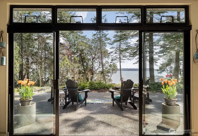 a view of a porch with a dining table and chairs