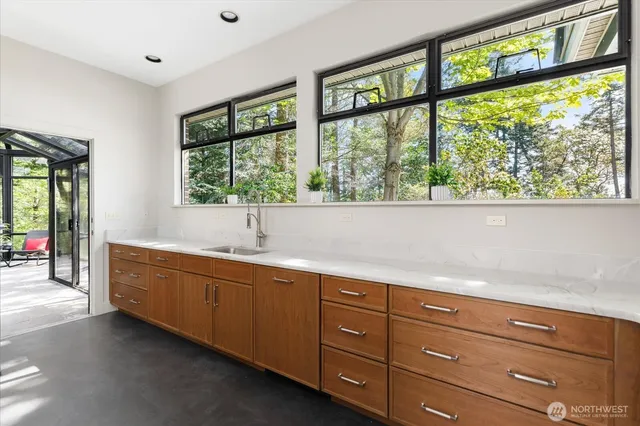 a large white kitchen with a large window