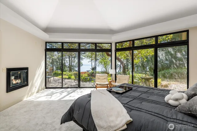 a room with a bed and glass windows