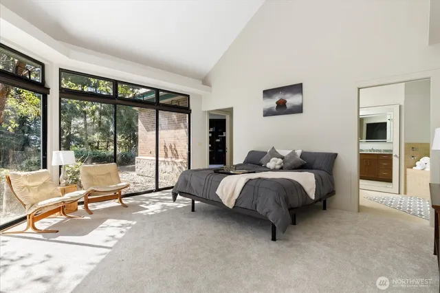 a spacious bedroom with a bed and large window