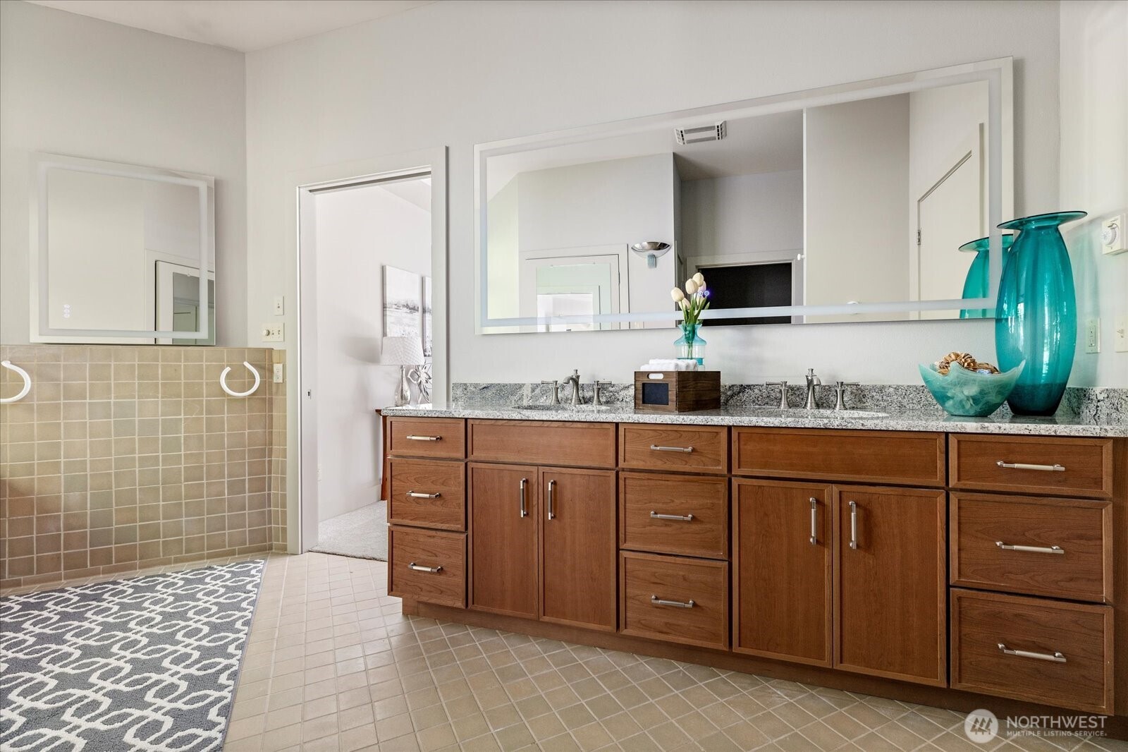 1912 East Hunskor Road Oak Harbor, WA 98277 - Photo 24 of 40 a spacious bathroom with a granite countertop sink and a mirror