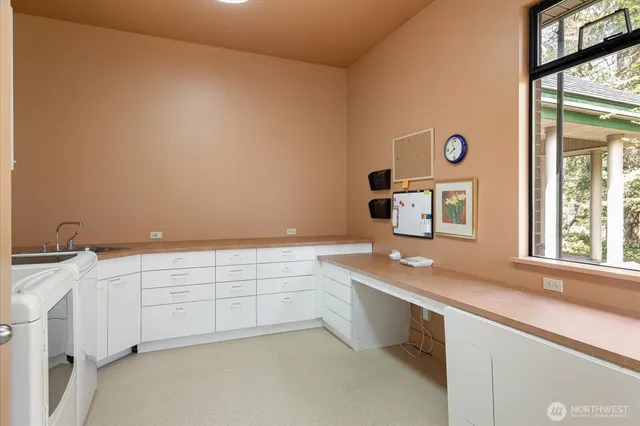 a room with a sink and cabinets