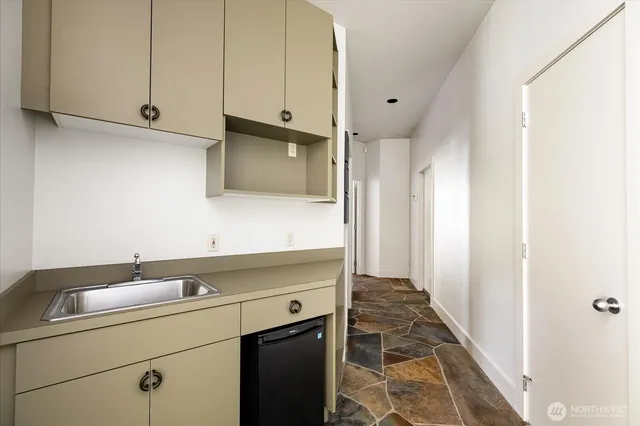 a view of a bathroom with sink and mirror
