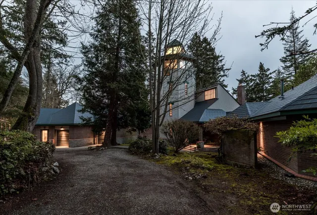 a view of a house with a yard and tree s