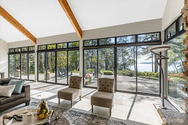 a living room with furniture and a floor to ceiling window