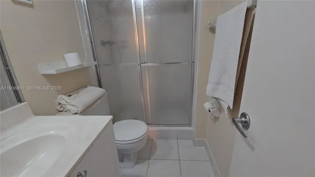 a white toilet sitting next to a bathroom sink