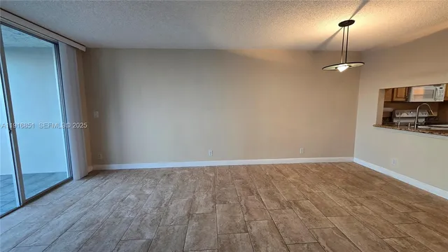 an empty room with wooden floor and cabinet