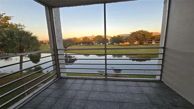 a view of swimming pool with patio and lake view