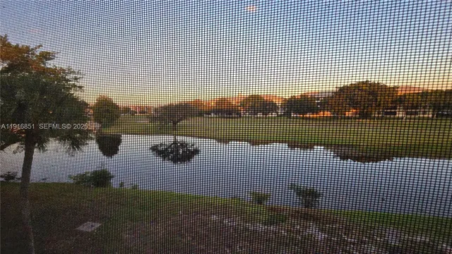 an empty room with closet and windows