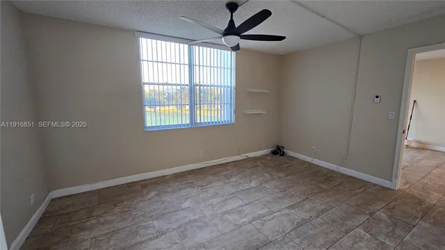 a view of an empty room with a window