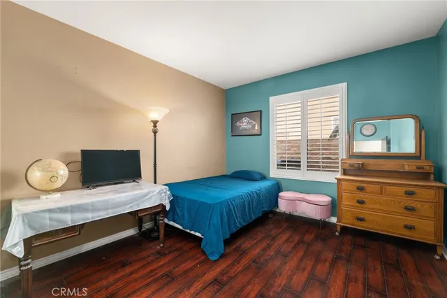 a bedroom with a bed and window
