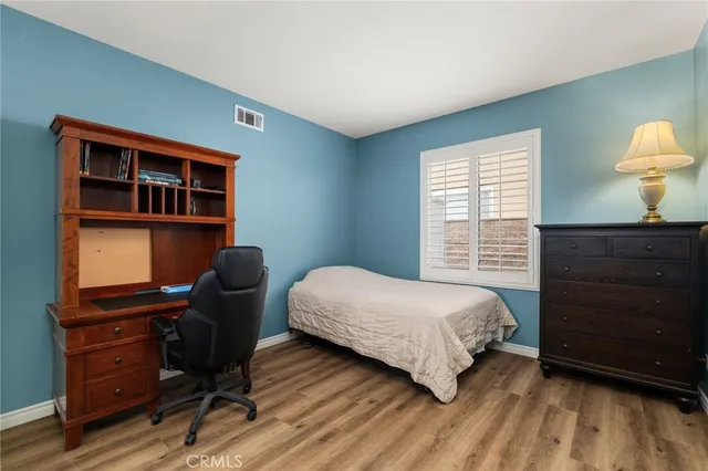 a bedroom with a bed and a desk