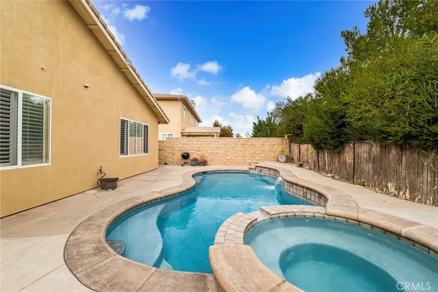 a swimming pool with outdoor seating and yard