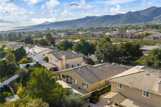 an aerial view of houses with a city