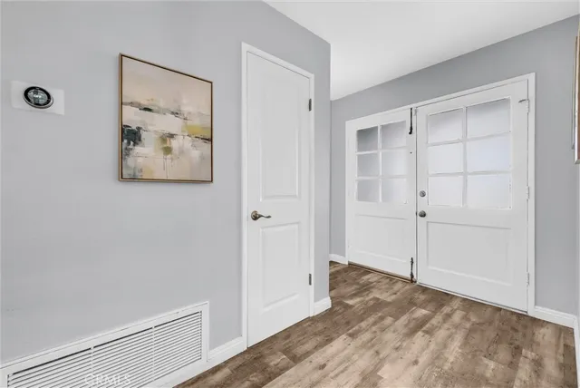 a view of an empty room with closet and a window